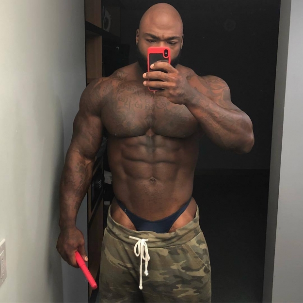 Black bodybuilder in skimpy briefs