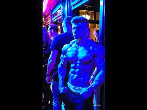 hot guy standing in front of a club