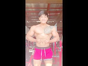 Hot guy flexing muscles at the gym