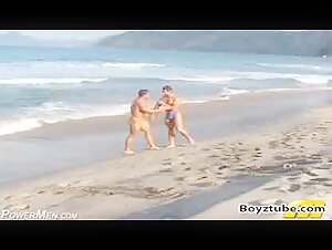 Bodybuilders beach wrestling